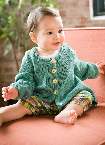 Baby cardigan featuring U-shaped plackets with ribbed stitches framed by graceful cables